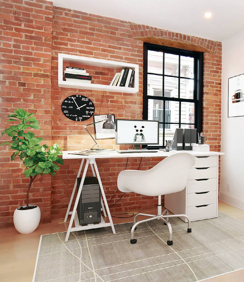Red brick office interior with black and white furnishings.